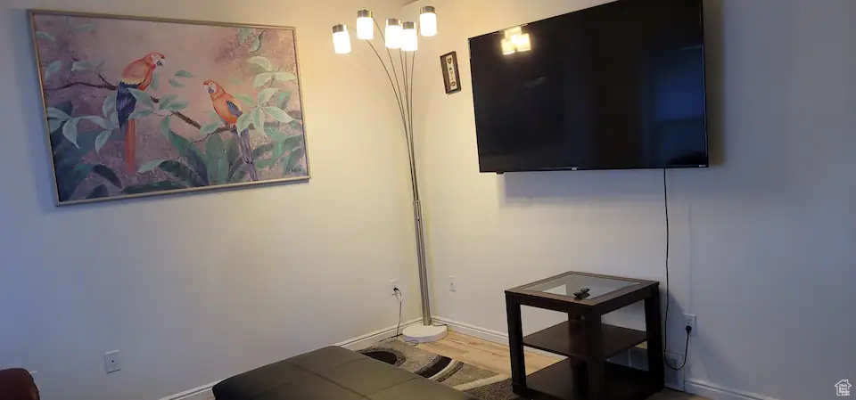 Living area featuring baseboards and wood finished floors