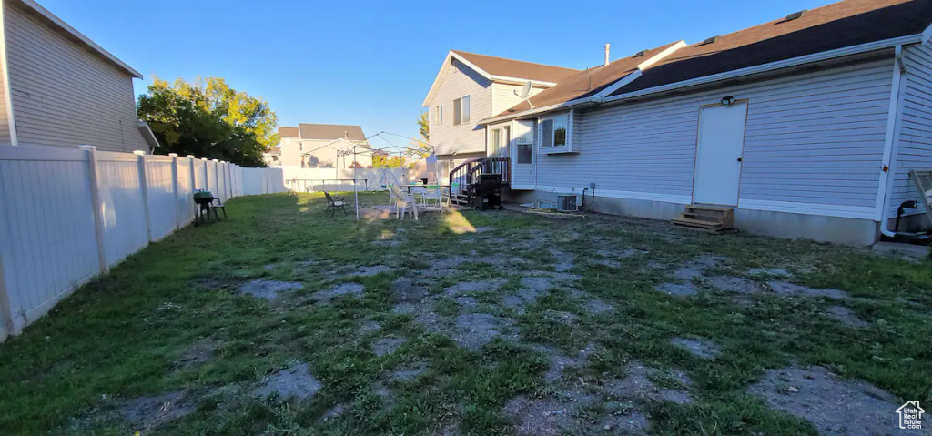 View of yard with entry steps and cooling unit