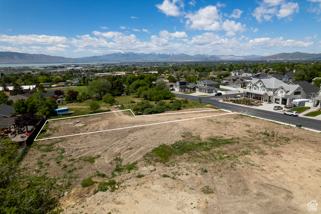Aerial perspective of suburban area with property boundaries highlighted and mountains