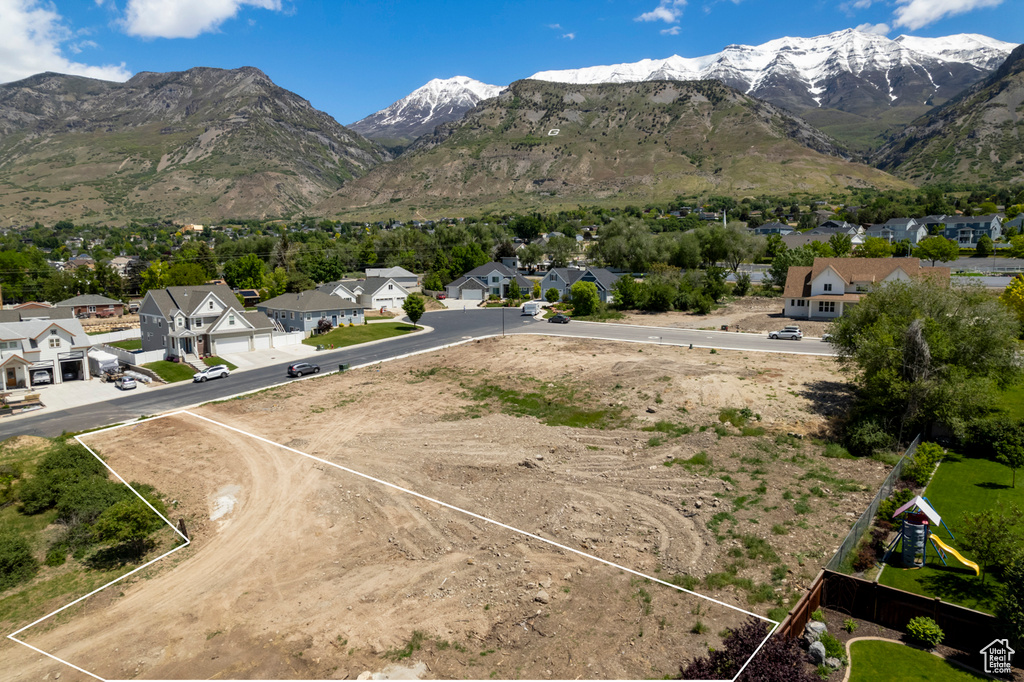View of mountain backdrop featuring nearby suburban area