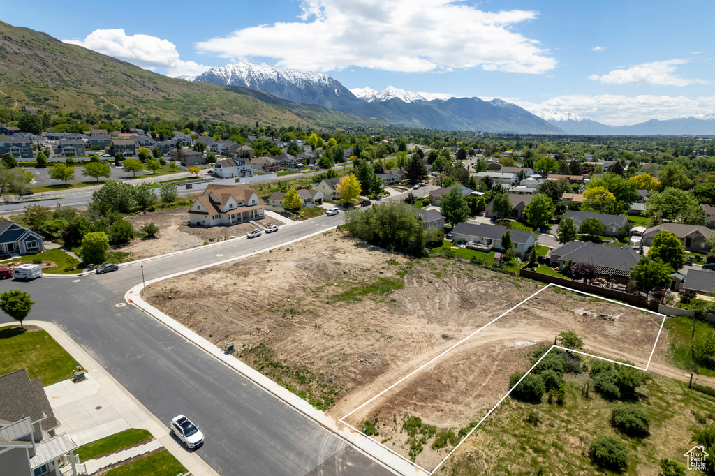 Aerial perspective of suburban area featuring mountains and property parcel outlined