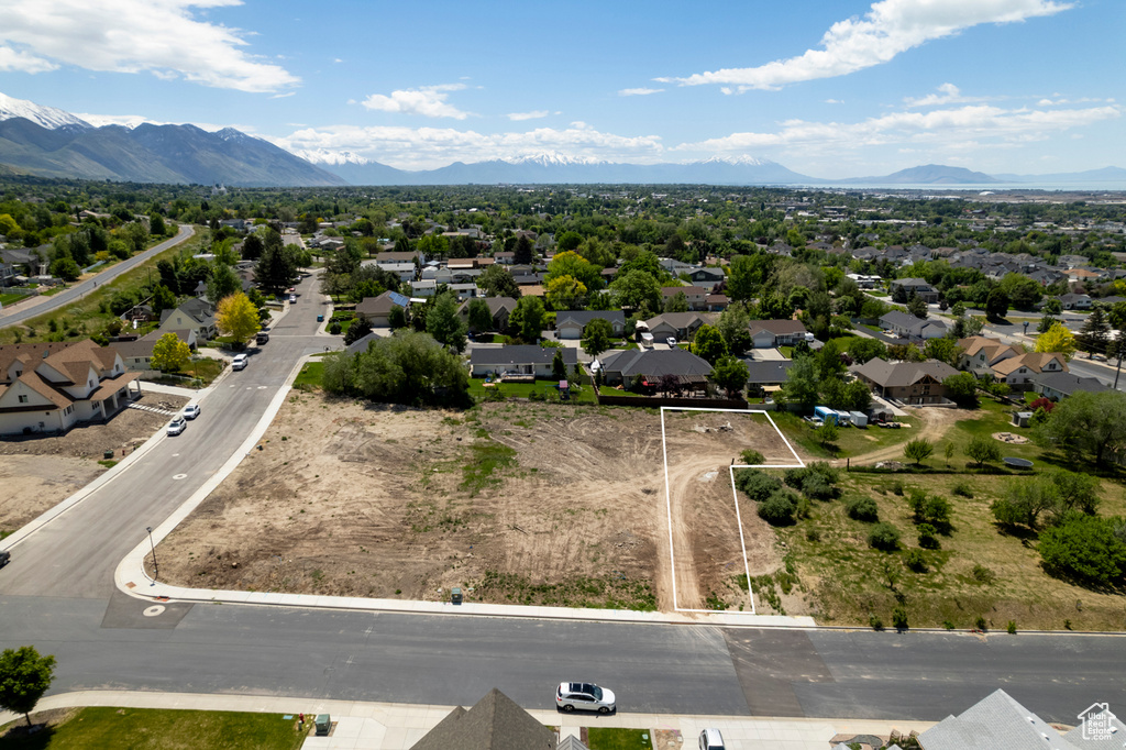 Aerial perspective of suburban area with mountains and property boundaries highlighted