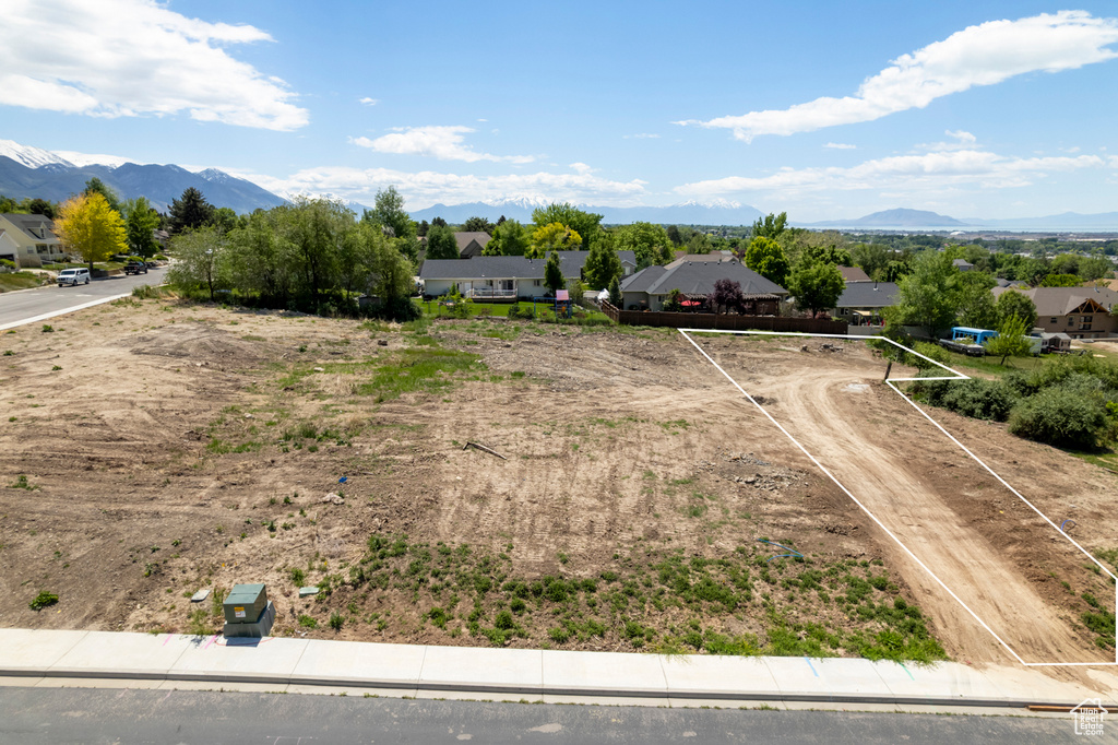 Aerial perspective of suburban area featuring mountains and property boundaries highlighted