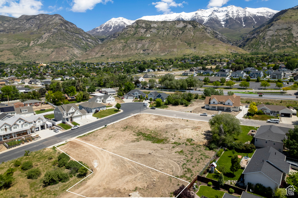 Aerial view of residential area with a mountainous background and property parcel outlined