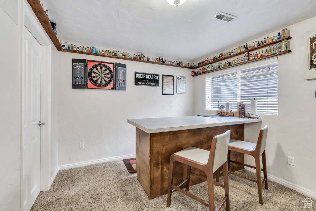 Bar area with carpet flooring and baseboards