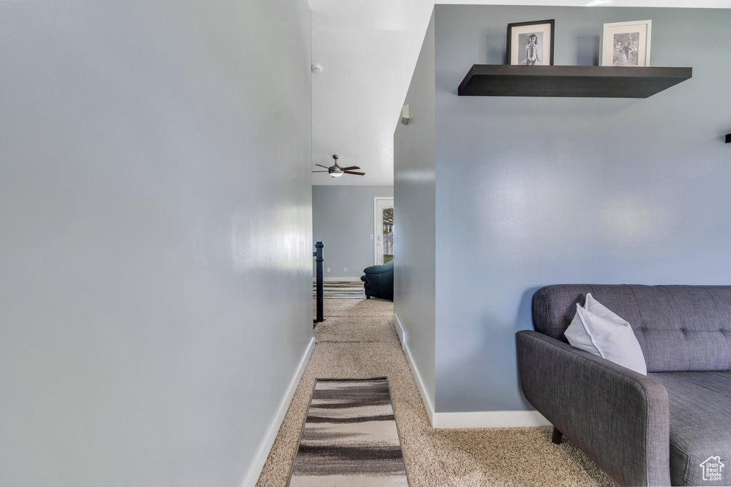 Hall with carpet flooring and baseboards