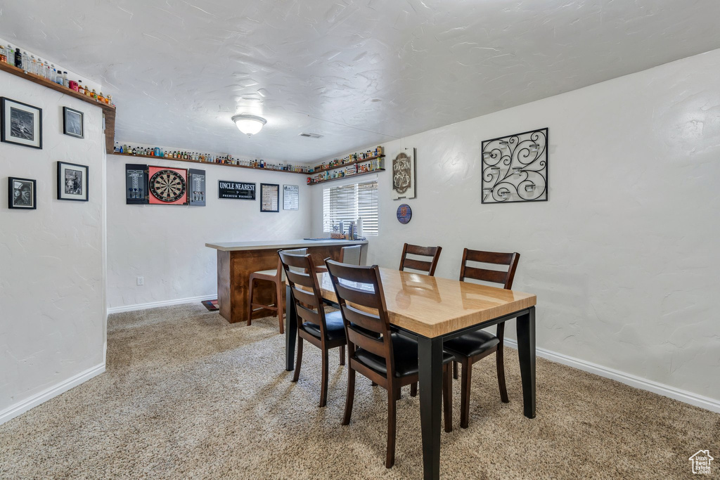 Dining area featuring light carpet and baseboards