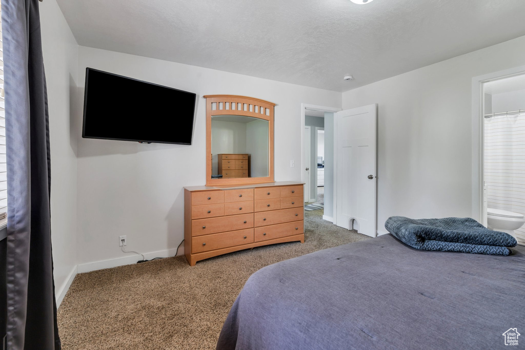 Bedroom featuring carpet and baseboards