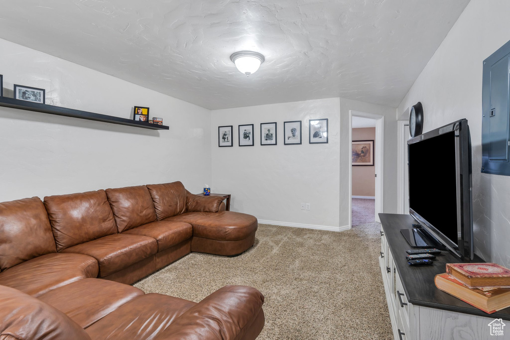 Living area with carpet, lofted ceiling, and baseboards