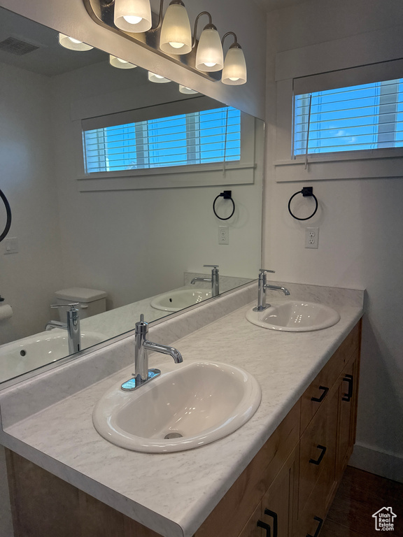Bathroom featuring double vanity and toilet