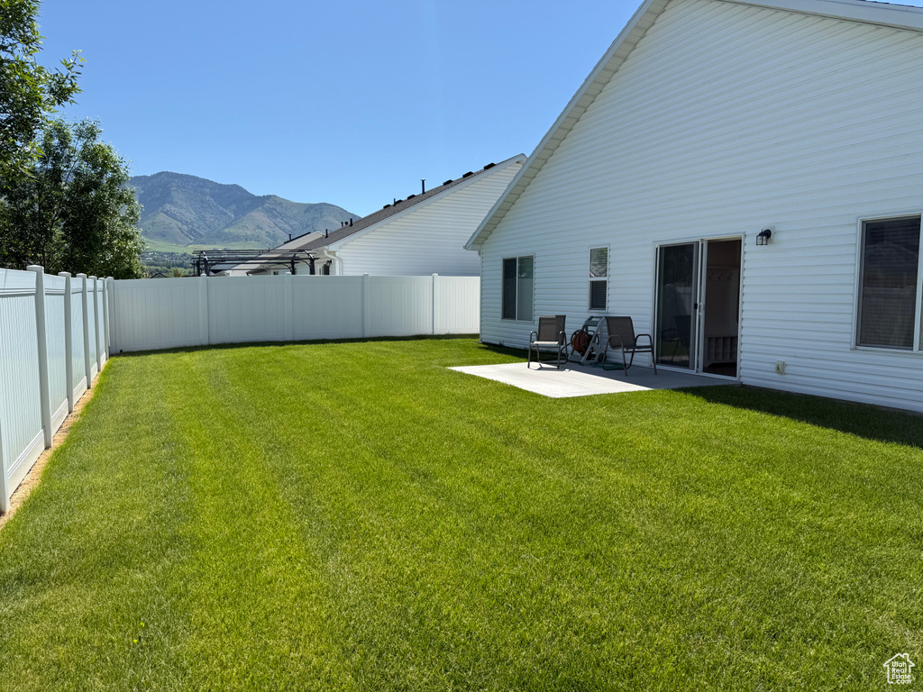 View of yard with a mountain view and a patio