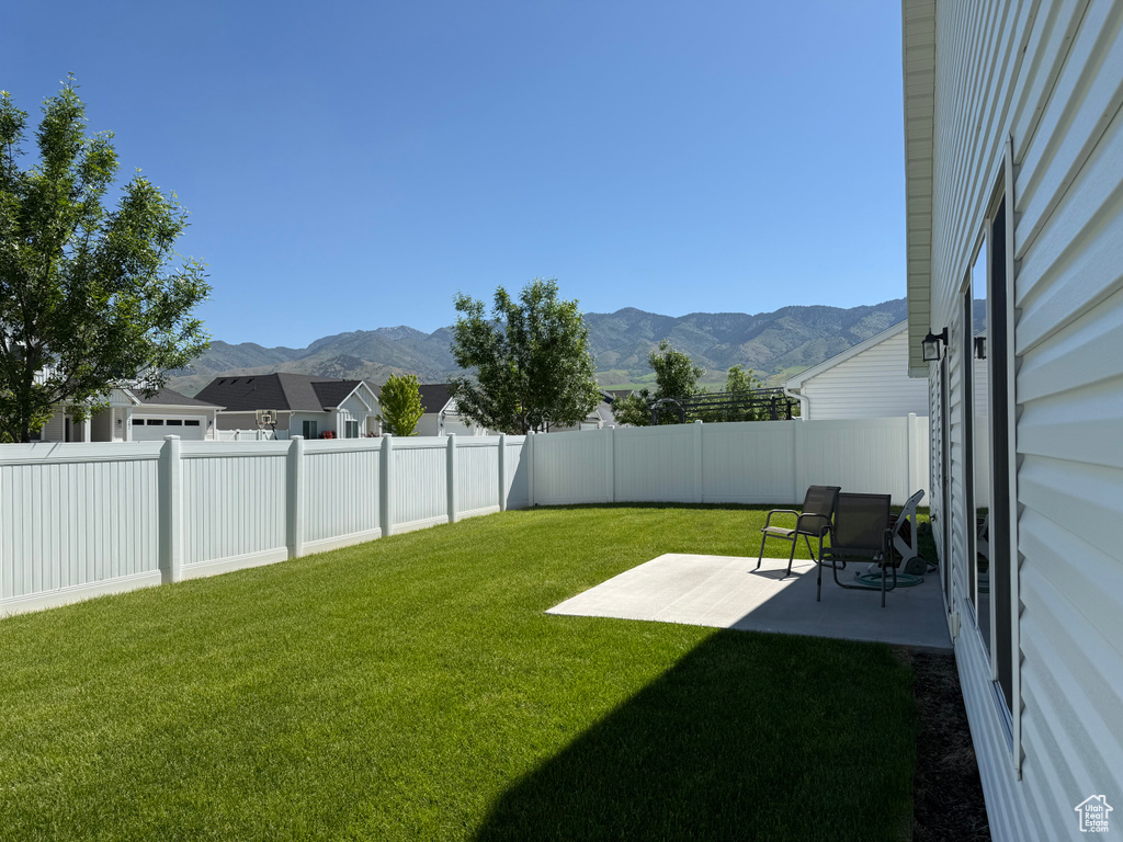 View of yard with a mountain view and a patio area