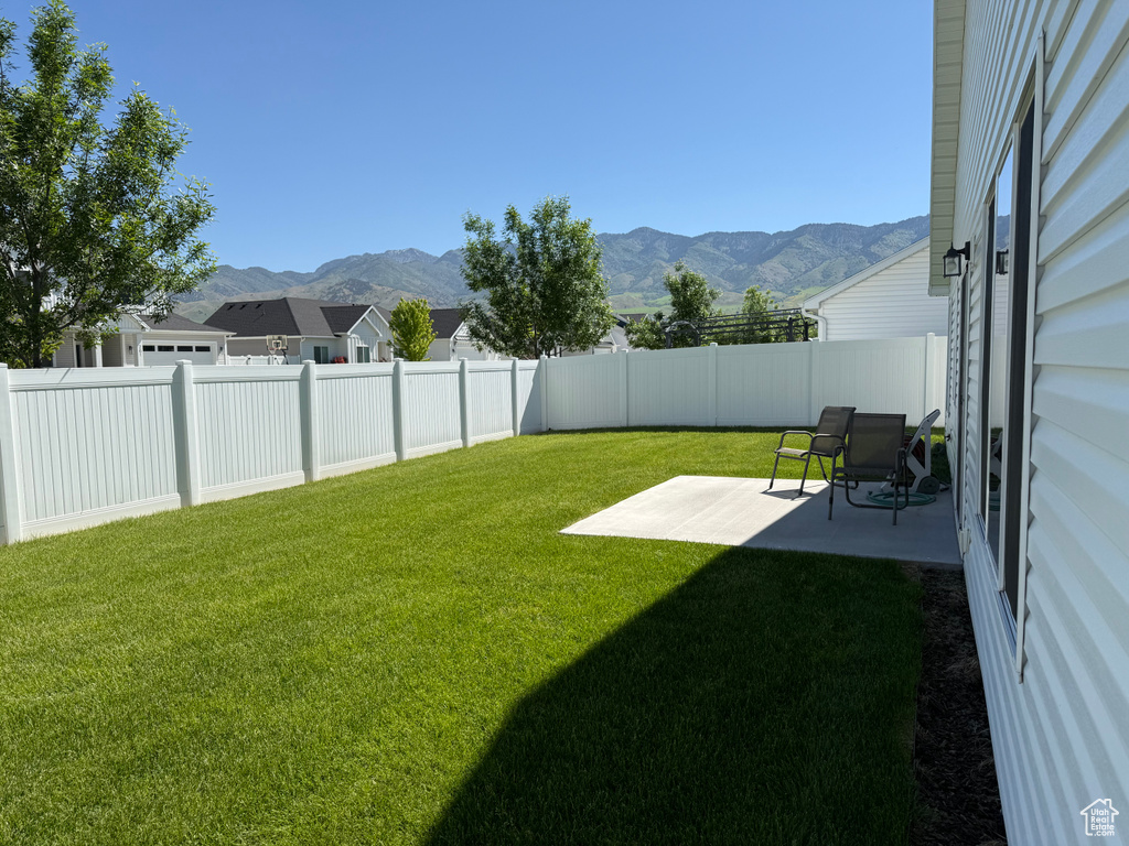 View of yard featuring a mountain view and a patio area