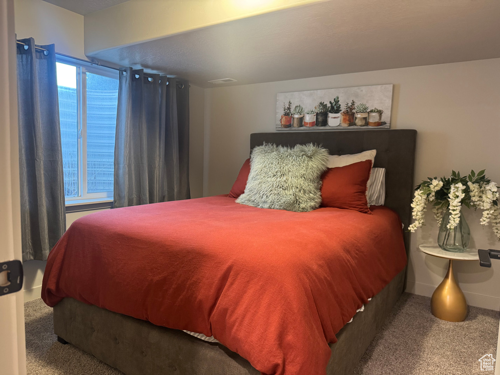 Carpeted bedroom with baseboards