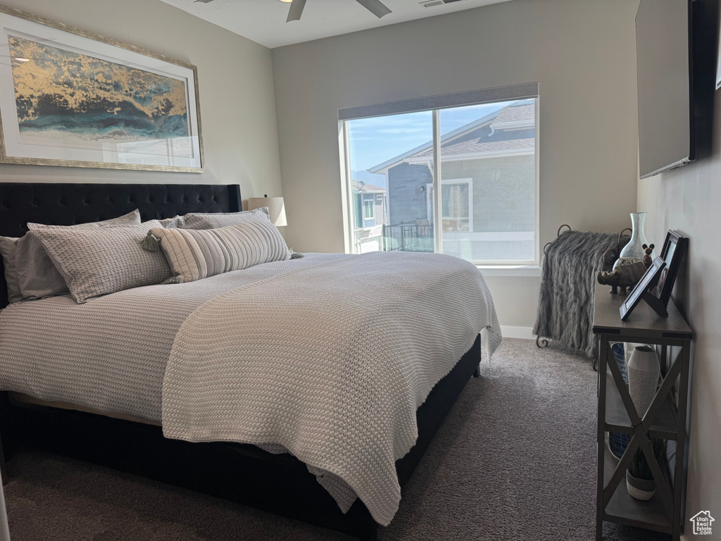 Carpeted bedroom featuring a ceiling fan