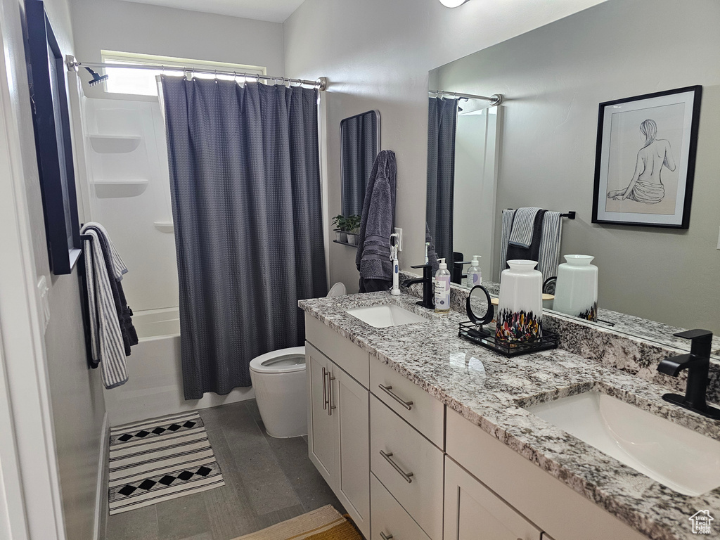 Full bath featuring double vanity and shower / bath combination with curtain