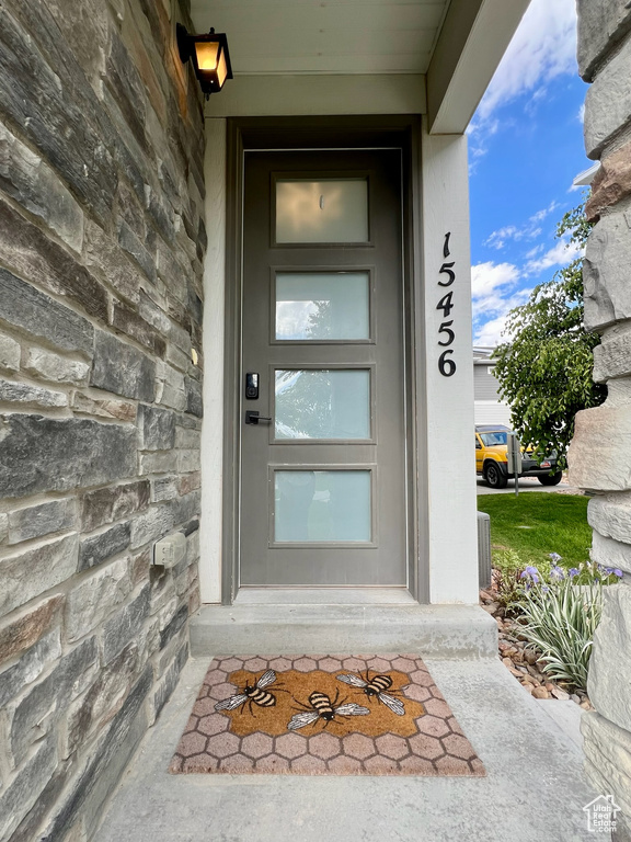 Entrance to property with stone siding