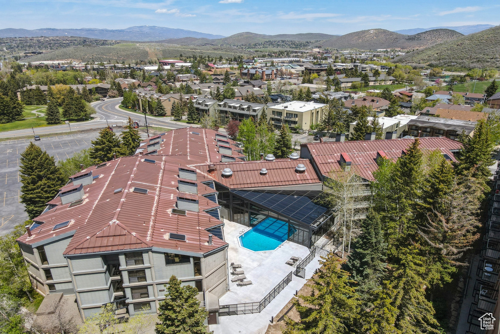 Drone / aerial view of mountains and a pool