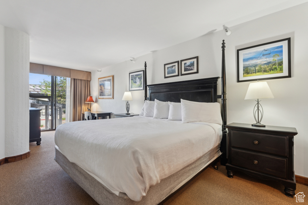 Bedroom featuring carpet flooring and baseboards