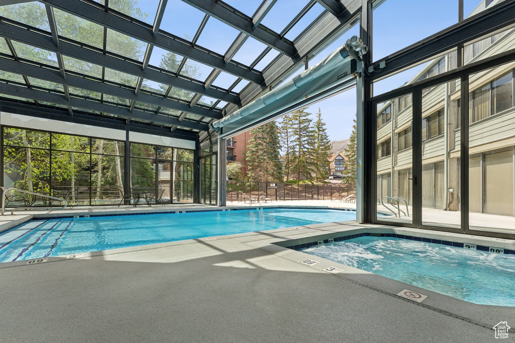 Community pool featuring a hot tub and a patio area