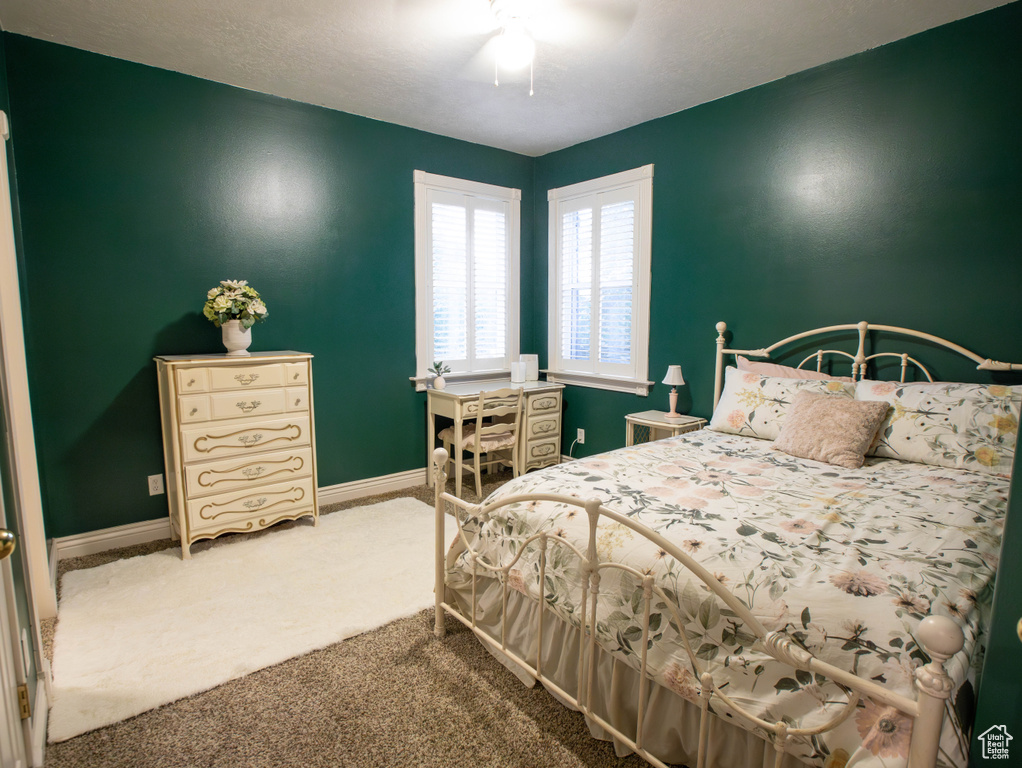 Bedroom featuring carpet floors, baseboards, and ceiling fan