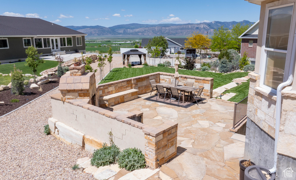 View of patio featuring a gazebo, a mountain view, and outdoor dining area