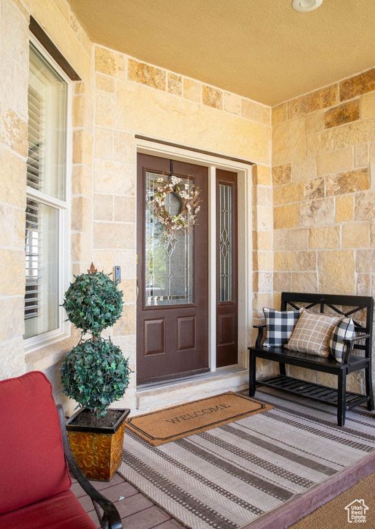 Doorway to property featuring stone siding