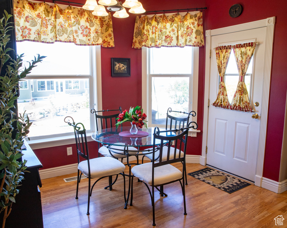 Dining room with light wood-type flooring and baseboards