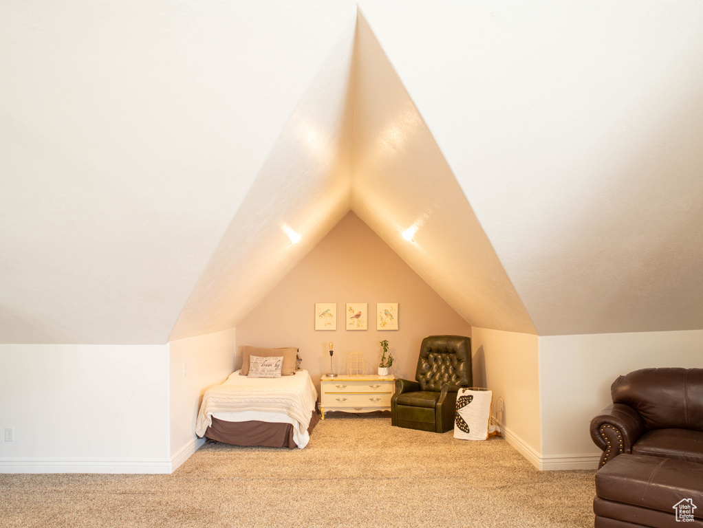 Bedroom with carpet, vaulted ceiling, and baseboards