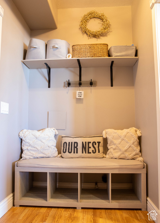 Mudroom featuring wood finished floors and baseboards
