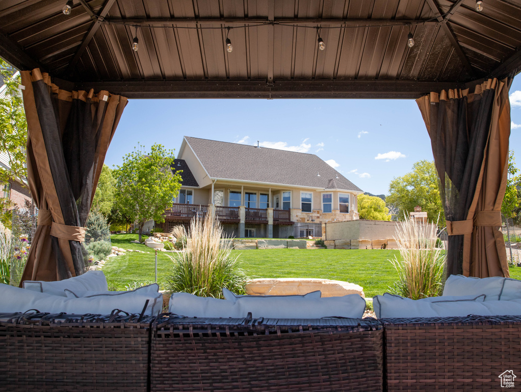 View of patio featuring an outdoor living space and a gazebo