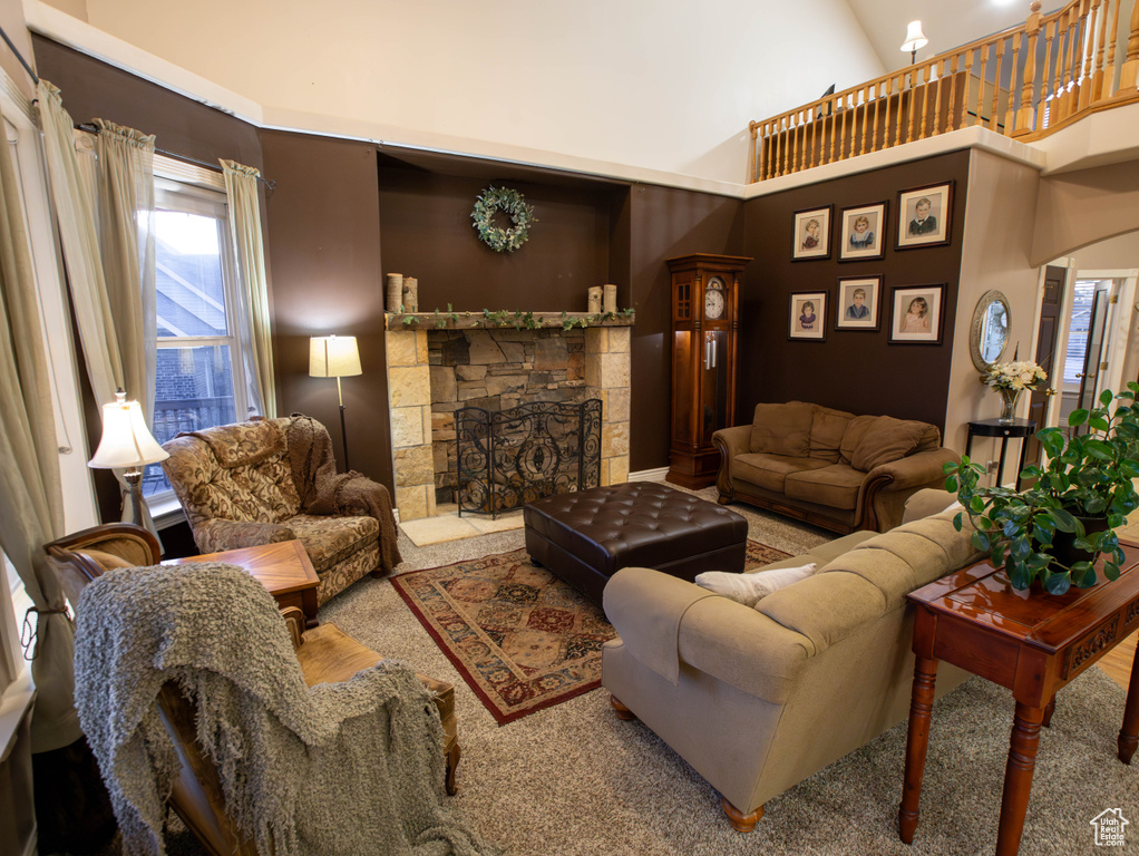 Living room featuring a fireplace and a towering ceiling