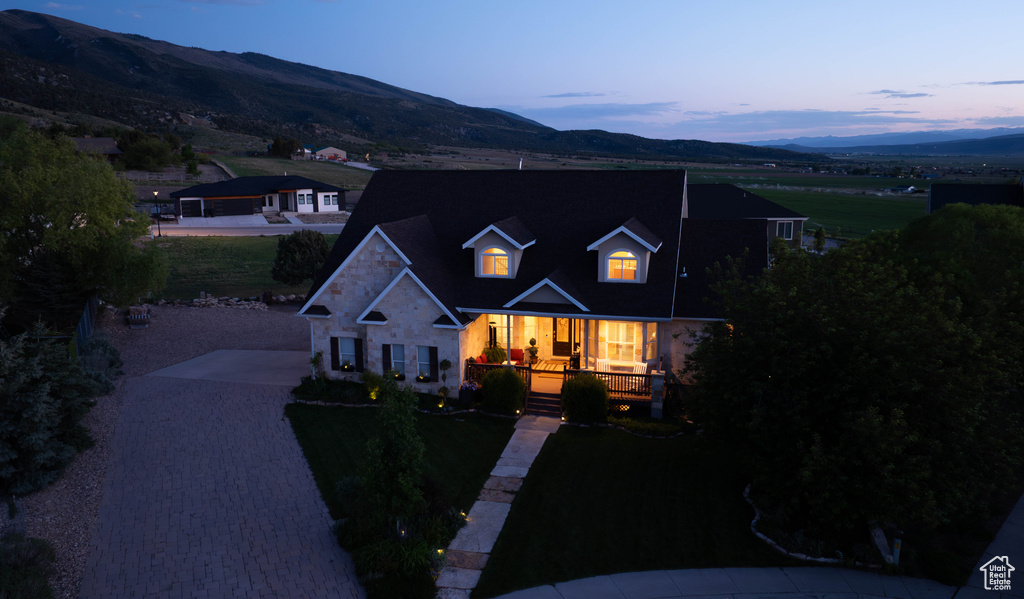 Traditional-style home with a mountain view, covered porch, and driveway