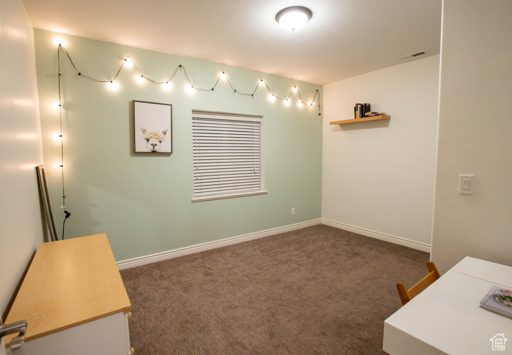 Empty room with carpet and baseboards