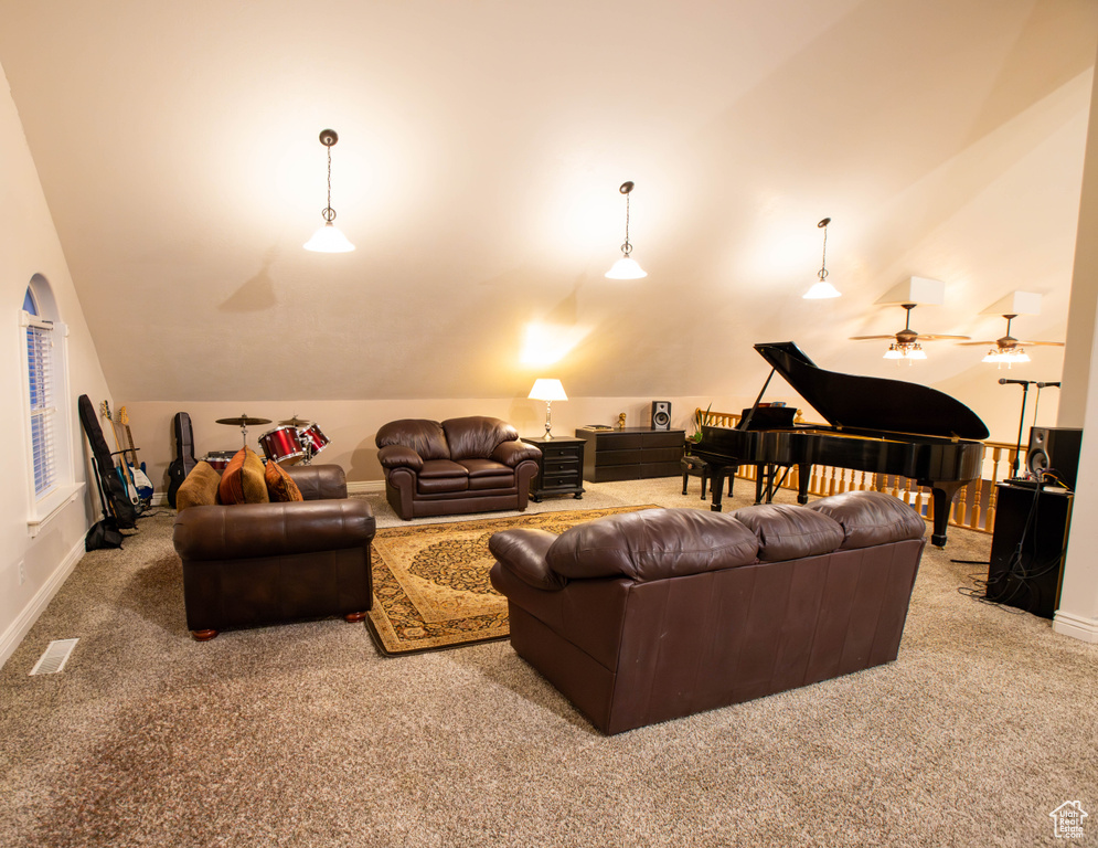 Carpeted living room featuring vaulted ceiling and baseboards