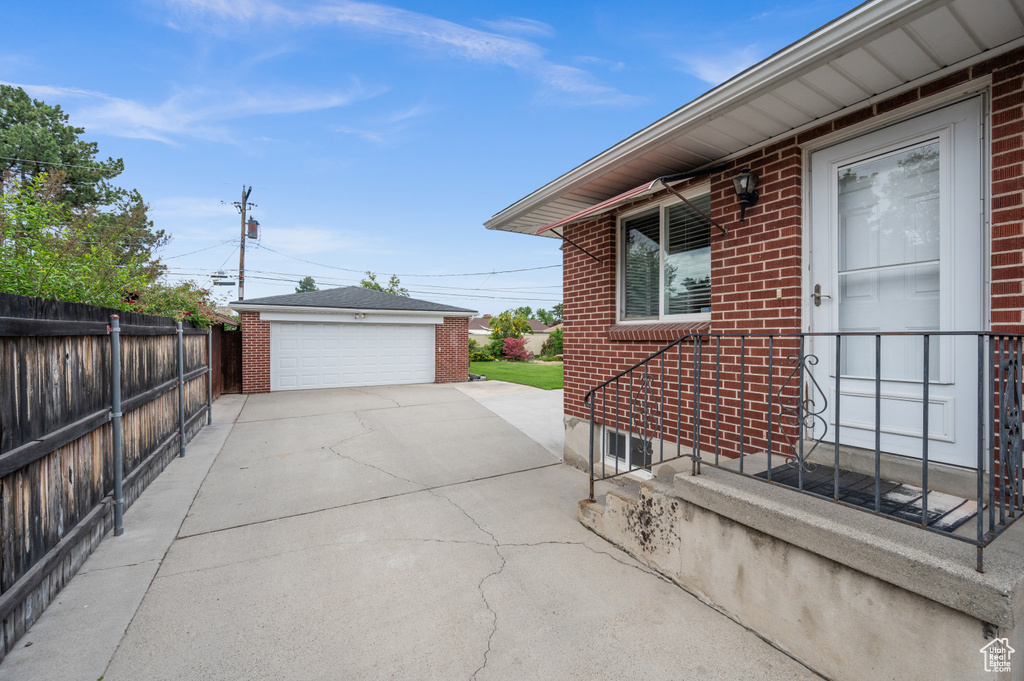 View of patio featuring a garage and an outdoor structure