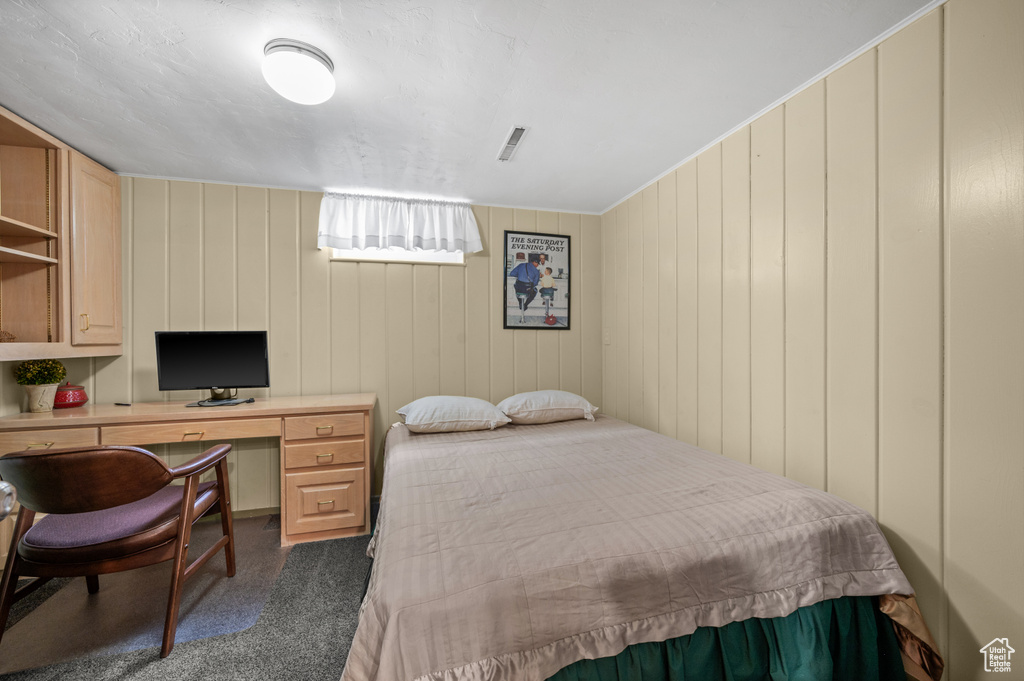 Bedroom with carpet floors and a desk