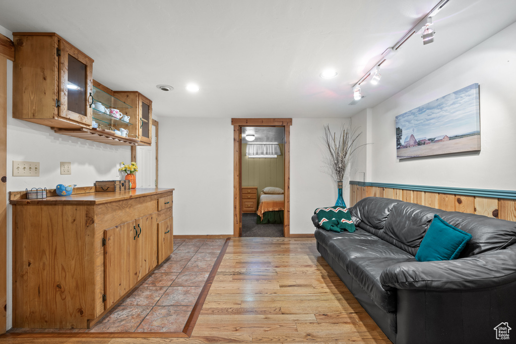 Living room with recessed lighting, light wood finished floors, track lighting, and baseboards