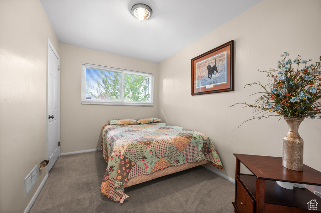 Carpeted bedroom featuring baseboards