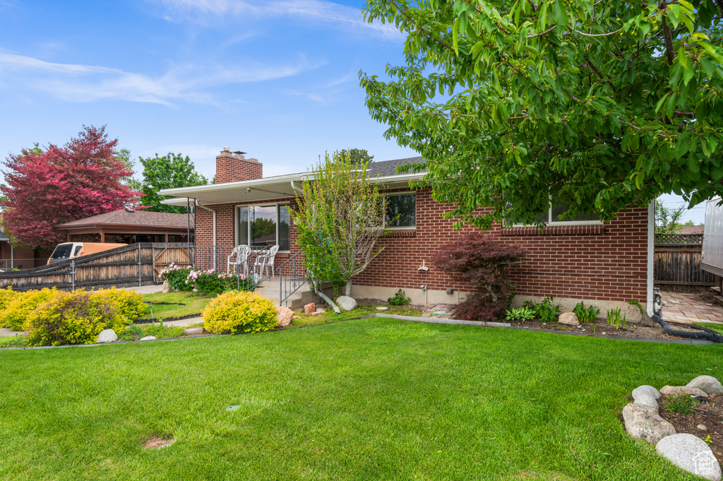 Back of property with brick siding and a chimney