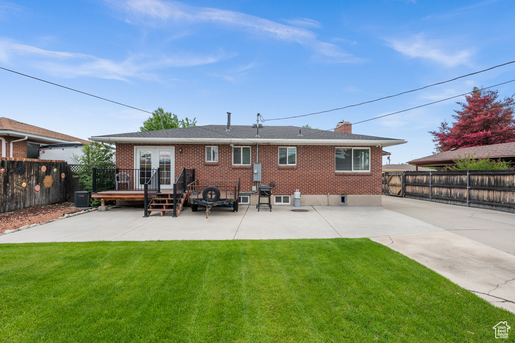 Back of house with a patio area, brick siding, french doors, and a wooden deck