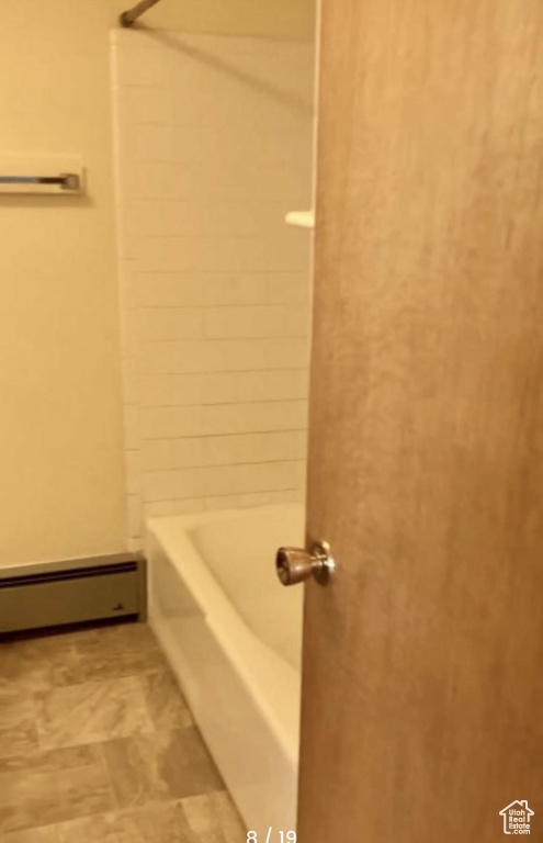 Full bath with a baseboard radiator