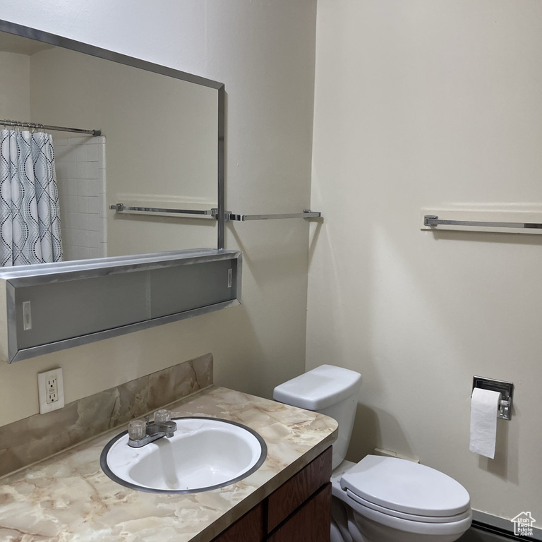 Full bathroom with vanity and curtained shower