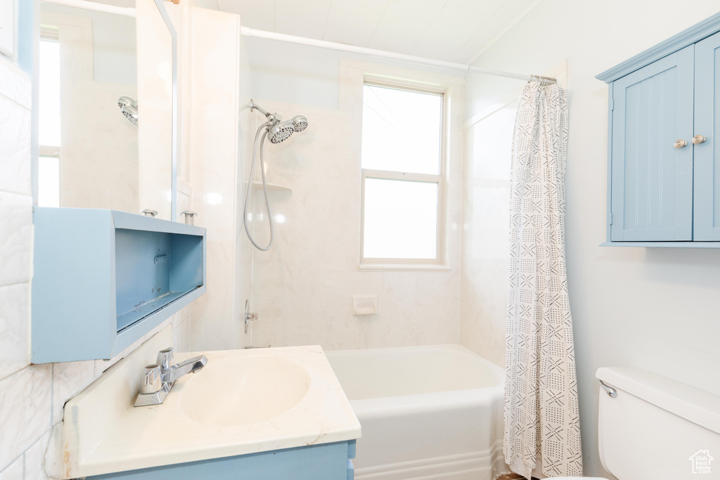 Full bathroom with shower / tub combo, toilet, and vanity