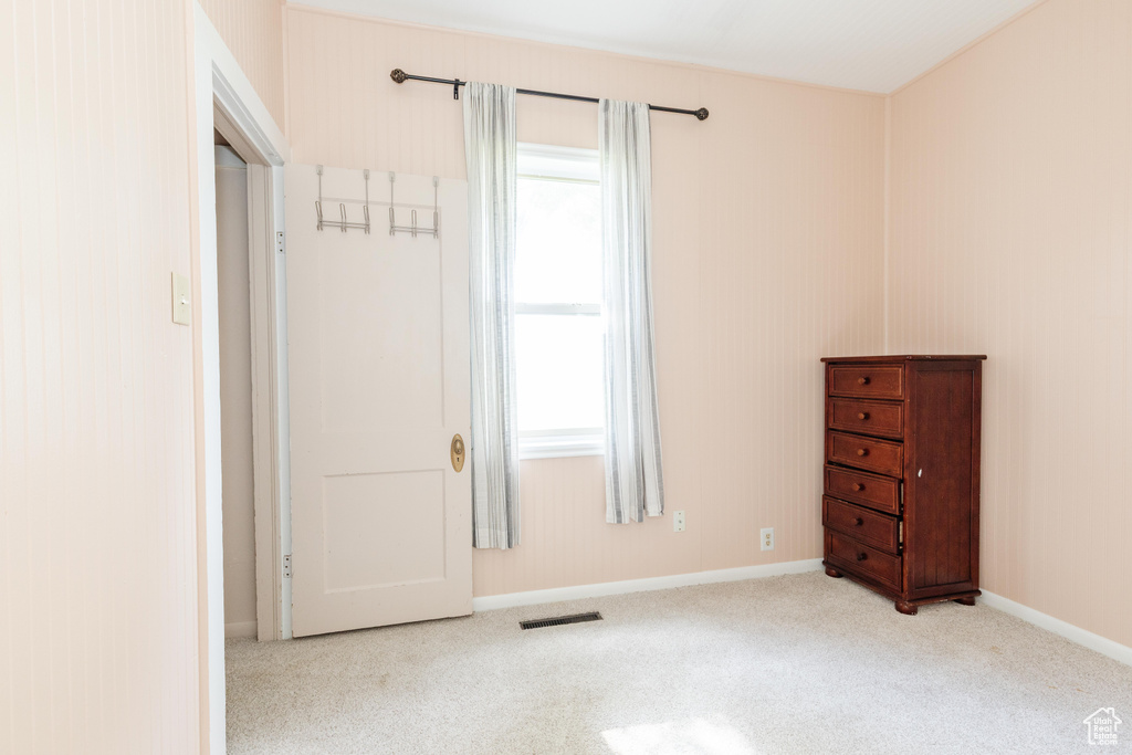 Unfurnished bedroom with multiple windows and carpet flooring