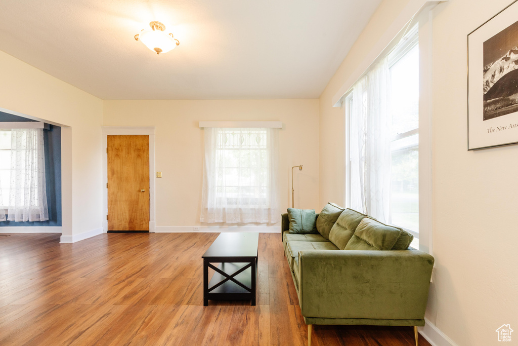 Living area with wood finished floors and baseboards