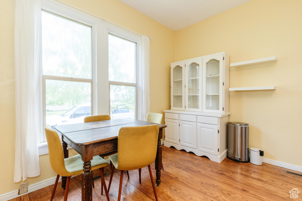Dining area featuring light wood-style floors and baseboards