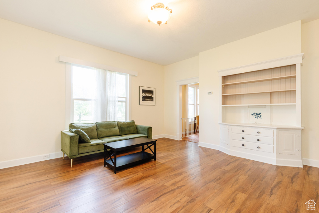 Living area with light wood-style flooring and baseboards