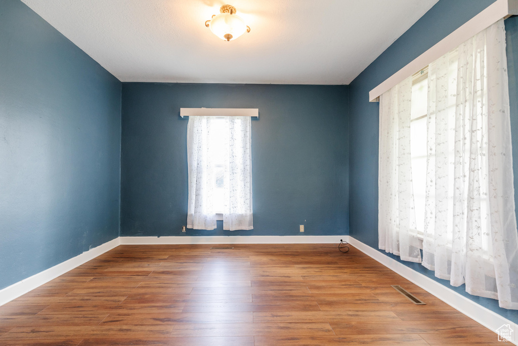 Spare room with wood finished floors and baseboards