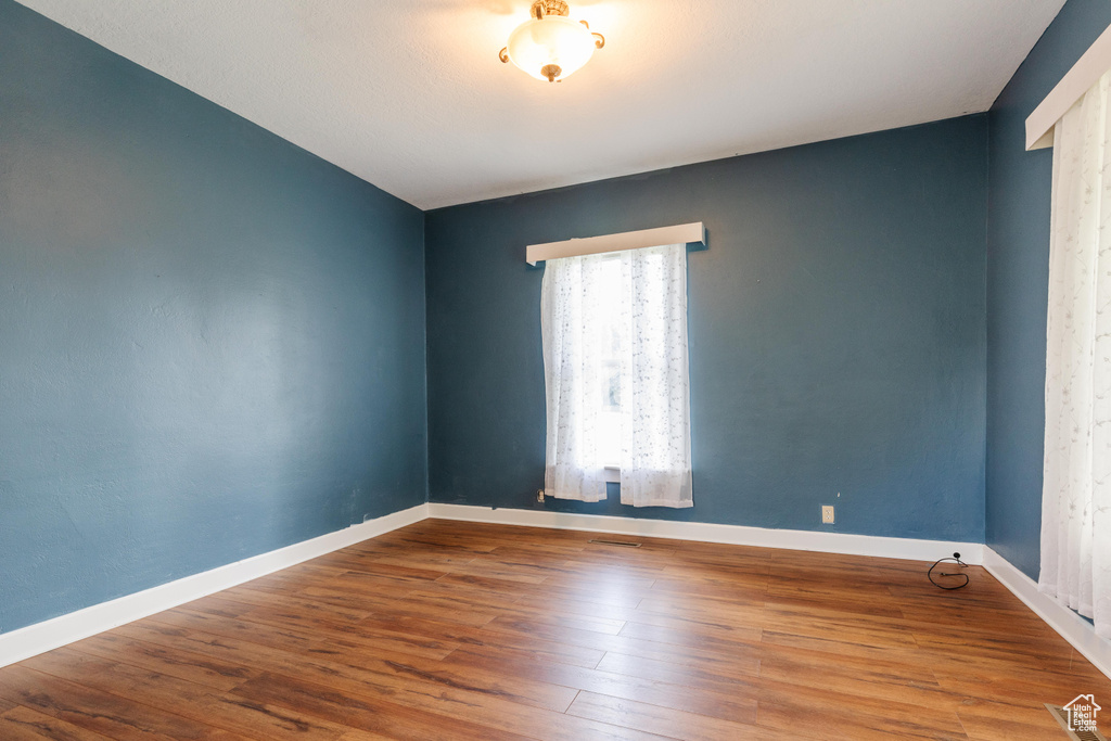 Empty room with wood finished floors and baseboards